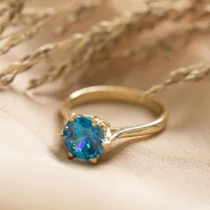 gold plated closed ring with blue cz 8mm facet